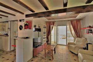 a living room with a couch and a television at Elisabet in Denia