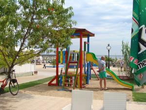a man playing on a playground in a park at Berlin Golden Beach Studio in Golden Sands