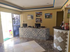 a room with a desk with two monitors on it at Hotel Veleiro de Porto in Porto De Galinhas