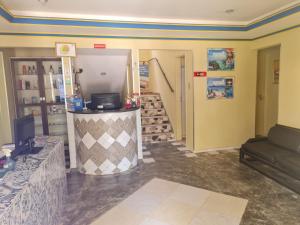 a lobby of a store with a couch and stairs at Hotel Veleiro de Porto in Porto De Galinhas