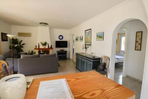 a living room with a table and a couch at Bárbara in Pedreguer