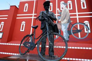 une statue d'un homme debout à côté d'un vélo dans l'établissement beb Da basso experience Napoli Toledo, Pompeii, Ercolano and Vesuvio, à San Giorgio a Cremano
