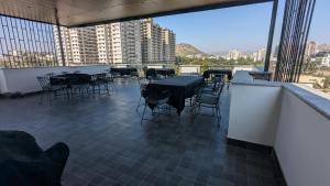 a patio with tables and chairs on a balcony at MAHA RAAS A unit of RAAS LEELA Hotels and Resort in Udaipur