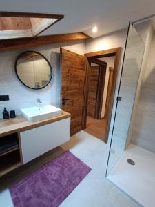 a bathroom with a sink and a mirror at kuglerhof in Dobbiaco
