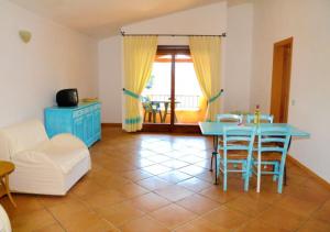 a living room with a blue table and chairs at Marinella Residence in Santa Marinella