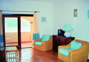 a living room with two chairs and a television at Marinella Residence in Santa Marinella
