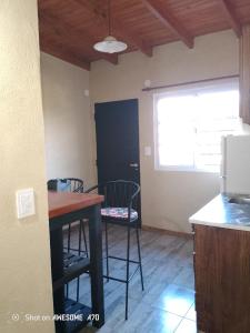 a kitchen with a table and chairs in a room at Lo de tina in Florencio Varela