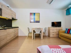 a room with a kitchen and a table with chairs at Studio Harrachov by Interhome in Harrachov