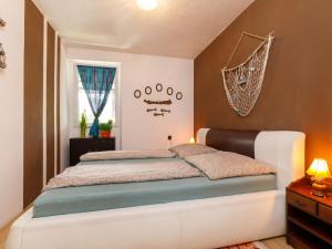 a bedroom with a large bed in a room at Apartment Gagarin 2 by Interhome in Balatonkeresztúr