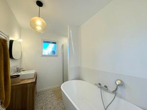 康布里特Lilas, maison de charme à Sainte Marine près de la mer的带浴缸和水槽的白色浴室 更多16张照片