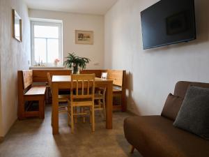 a living room with a table and chairs and a couch at Chalet Jizerky Paws & Sauna by Interhome in Kořenov +36 photos