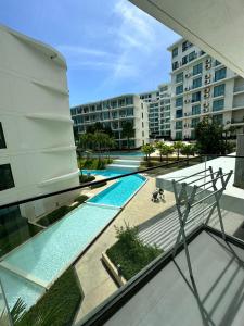 a view of a swimming pool from a balcony of a building at HomeAwayFromHome in Phuket