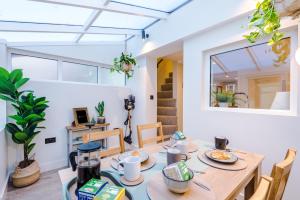 a dining room with a table and chairs at Foden's House by YourStays - 2 Bedroom Cottage in Sandbach with gorgeous dining room extension, High end finish in Sandbach