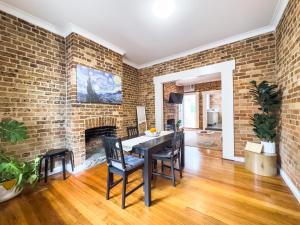 a dining room with a brick wall and a table and chairs at Serenity home in the heart of city in Sydney +16 photos