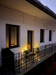 a house with candles on the balcony at night at Madalina's House in Braşov