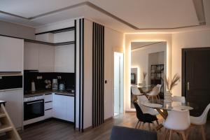 a kitchen and living room with a table and chairs at Εμμέλεια in Karpenisi