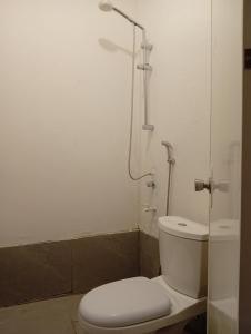 a bathroom with a toilet and a shower at El Hermosa Beach Resort in El Nido