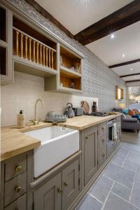 a kitchen with a sink and a counter top at Maltings Cottage in Barnard Castle