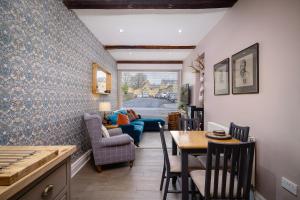 a kitchen and dining room with a table and chairs at Maltings Cottage in Barnard Castle