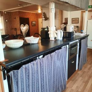 a kitchen with a black and blue counter top at Stall Norrby in Norrby