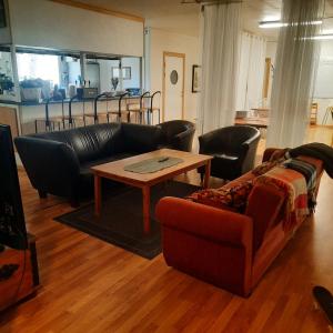a living room with a couch and a coffee table at Stall Norrby in Norrby