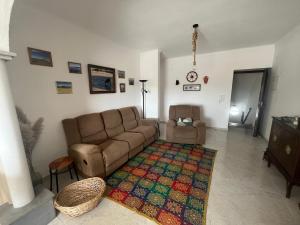 a living room with a couch and a chair at Vista Mourisca in Mourão