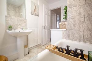a white bathroom with a sink and a bath tub at Central Cactus Escape Ideal for Long Stays 10ppl! in Nether Edge