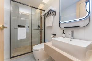 a bathroom with a toilet and a sink and a shower at Shanghai Manhua Hotel-Provides free shuttle service to Disneyland in Shanghai
