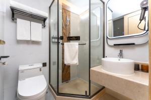 a bathroom with a toilet and a sink at Shanghai Manhua Hotel-Provides free shuttle service to Disneyland in Shanghai