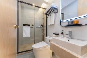a bathroom with a toilet and a sink and a shower at Shanghai Manhua Hotel-Provides free shuttle service to Disneyland in Shanghai