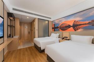 a hotel room with two beds and a tv at Shanghai Manhua Hotel-Provides free shuttle service to Disneyland in Shanghai