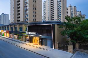 a store on a city street with tall buildings at Shanghai Manhua Hotel-Provides free shuttle service to Disneyland in Shanghai
