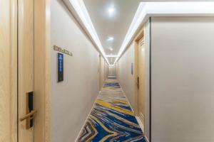 a hallway with a colorful carpet on the floor at Shanghai Manhua Hotel-Provides free shuttle service to Disneyland in Shanghai