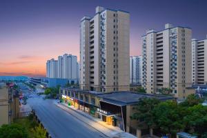 a view of a city with tall buildings and a street at Shanghai Manhua Hotel-Provides free shuttle service to Disneyland in Shanghai