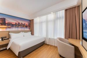 a hotel room with a bed and a tv at Shanghai Manhua Hotel-Provides free shuttle service to Disneyland in Shanghai