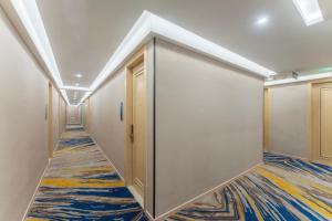 a corridor with doors and a carpet at Shanghai Manhua Hotel-Provides free shuttle service to Disneyland in Shanghai
