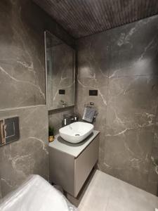 a bathroom with a sink and a mirror at Long Wood Hills Cottage in Ooty