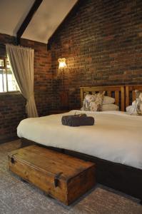 a bedroom with two beds with a wooden box on it at Grincourt B&B- with No Load shedding in Polokwane +116 photos