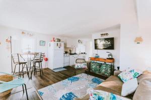 a living room with a couch and a kitchen at NH337A Coastal Dunes 1 in Nags Head