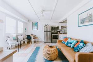 a living room with a couch and a kitchen at NH337D Coastal Dunes 4 in Nags Head