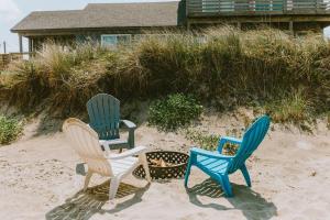 three chairs sitting in the sand on the beach at NH337D Coastal Dunes 4 in Nags Head