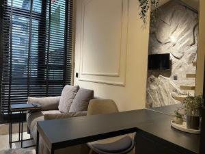 a living room with a couch and a table at Garage Apartments in Bajina Bašta