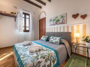 a bedroom with a bed with towels on it at Estay - Charm in Villanova in Cagliari