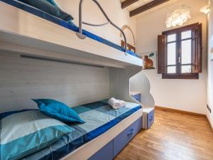 a bedroom with a bunk bed with blue pillows at Estay - Charm in Villanova in Cagliari