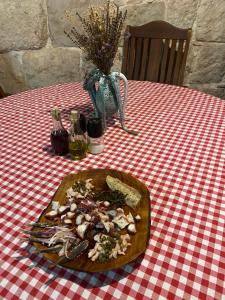 a plate of food on a red and white table at Apartman Marisari in Lastovo