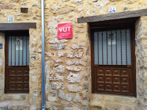 a stone building with two doors and a sign on it at Algarra Alojamientos in Algarra