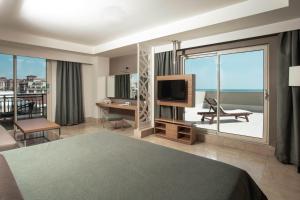a hotel room with a bed and a large window at Paloma Oceana in Side