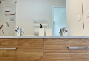 a bathroom with two sinks and a large mirror at Le Cottage du Lac, centre ville, LR124 in La Rochelle +66 photos