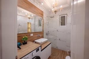 a bathroom with a sink and a mirror at Luxury Apartment in Sarandë