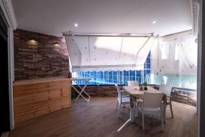 a dining room with a table and chairs and a window at Luxury Apartment in Sarandë +36 photos